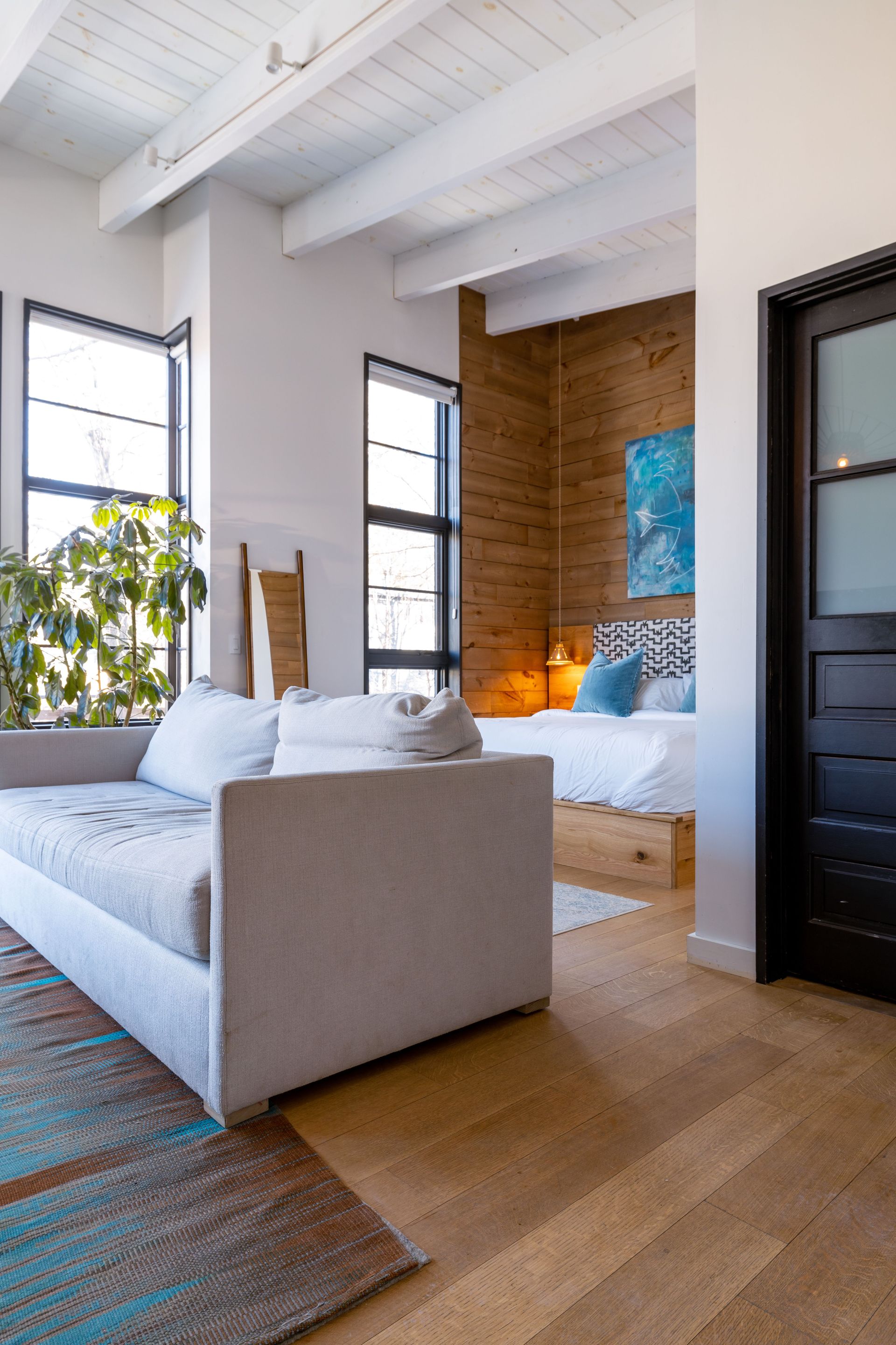 Contemporary cabin interior featuring a cozy bedroom with wooden accents and modern decor.